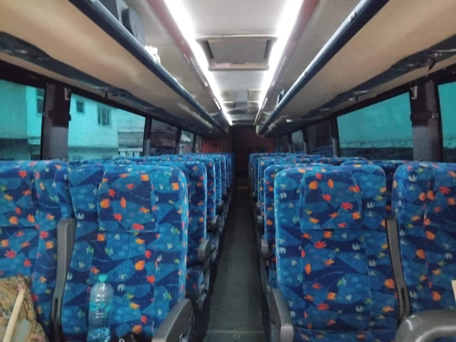 Interior real: asientos azules y pasillo